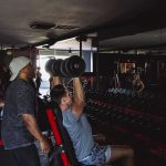 Personal trainer guiding client through customized strength training session at Physiques Gym in North Phoenix, Arizona.