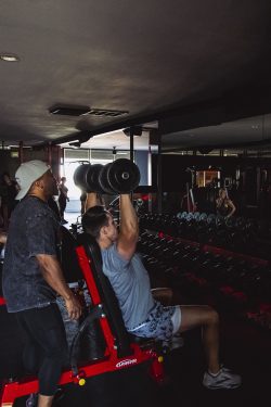 Personal trainer guiding client through customized strength training session at Physiques Gym in North Phoenix, Arizona.