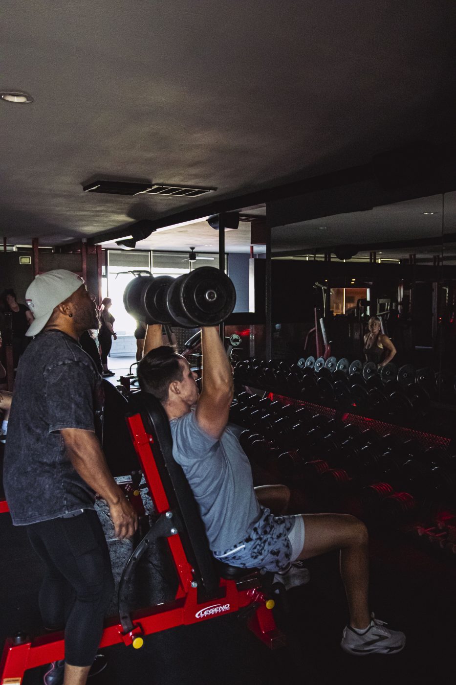 Personal trainer guiding client through customized strength training session at Physiques Gym in North Phoenix, Arizona.